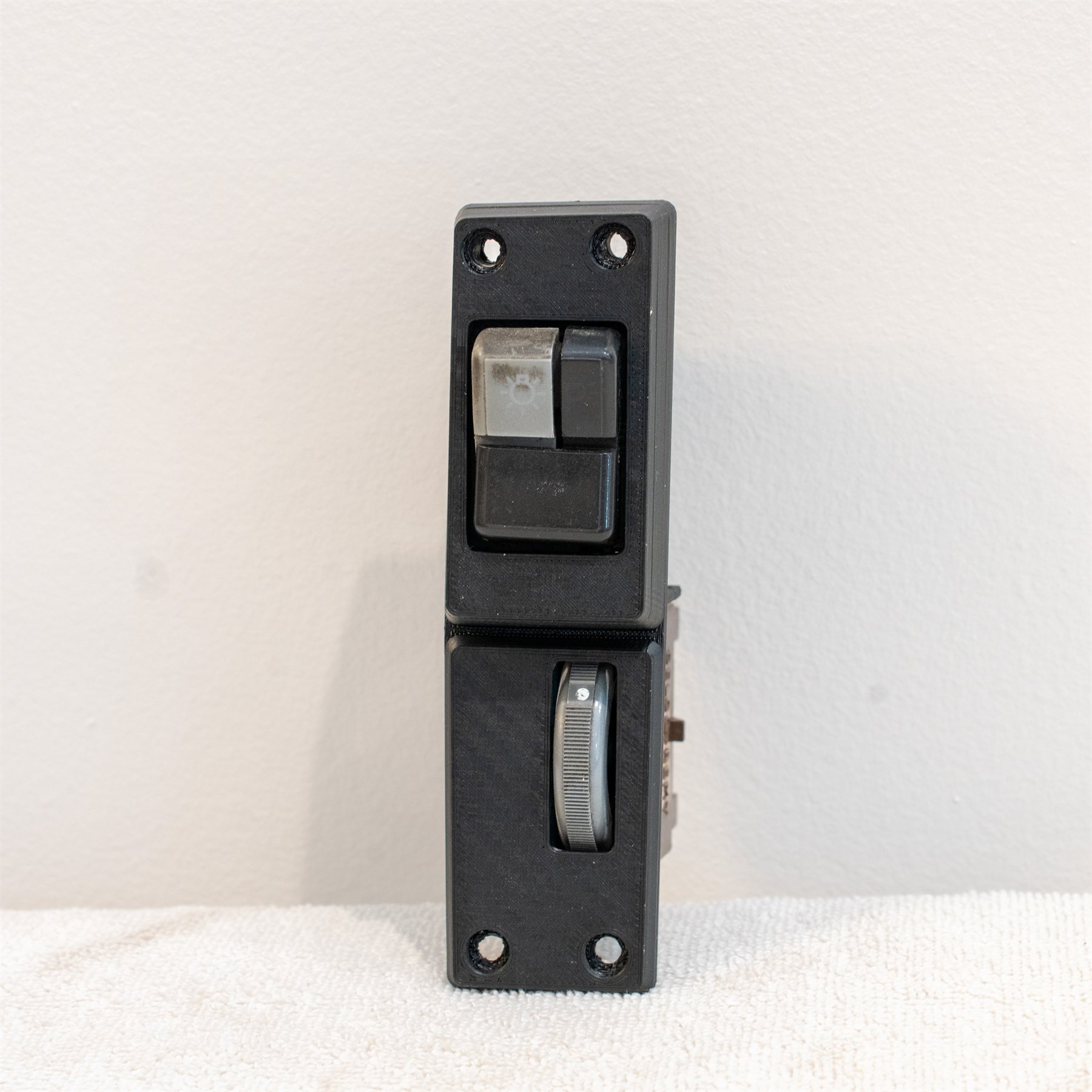 Reproduction Fiero driver-side cluster panel with factory switches installed, straight on
