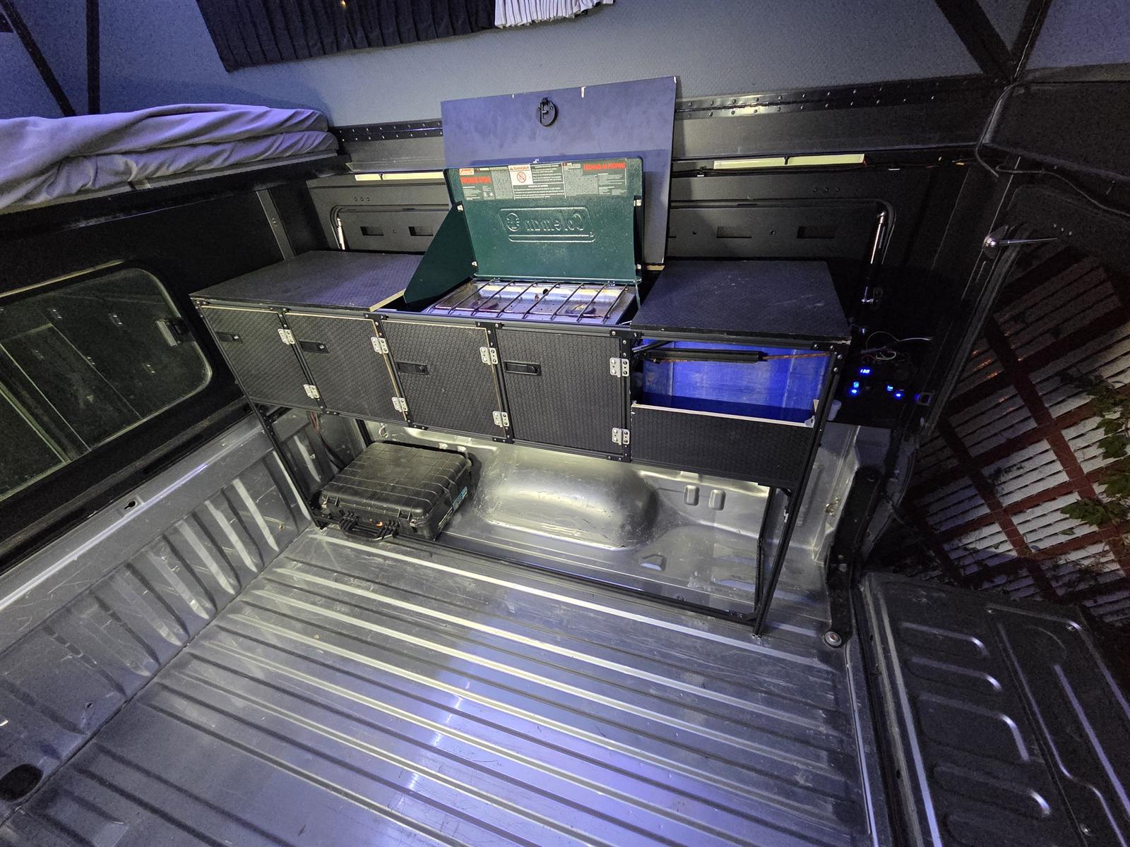 Removable galley cabinet with a camp stove installed in a pop-up truck camper